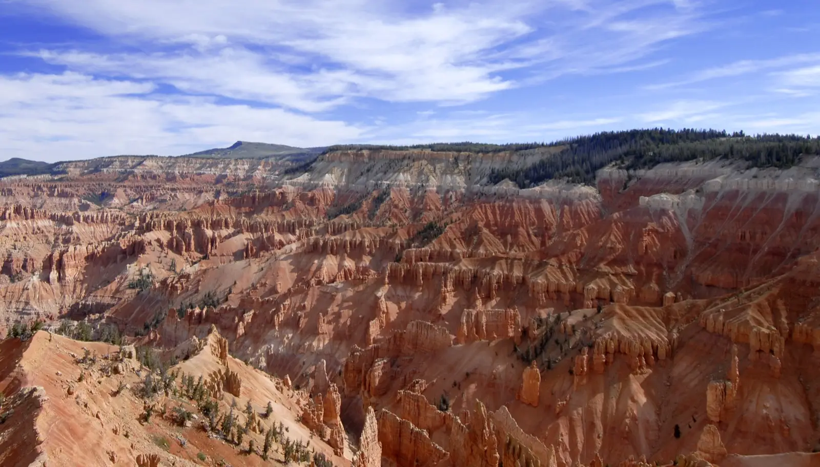 The pink and orange limestone amphitheater of Cedar Breaks National Monument carved into the high plateau