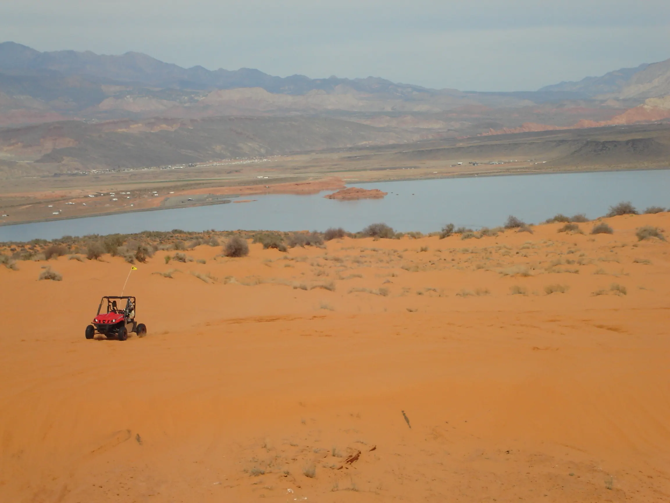 Sand Hollow Reservoir with red sand and red rock surroundings