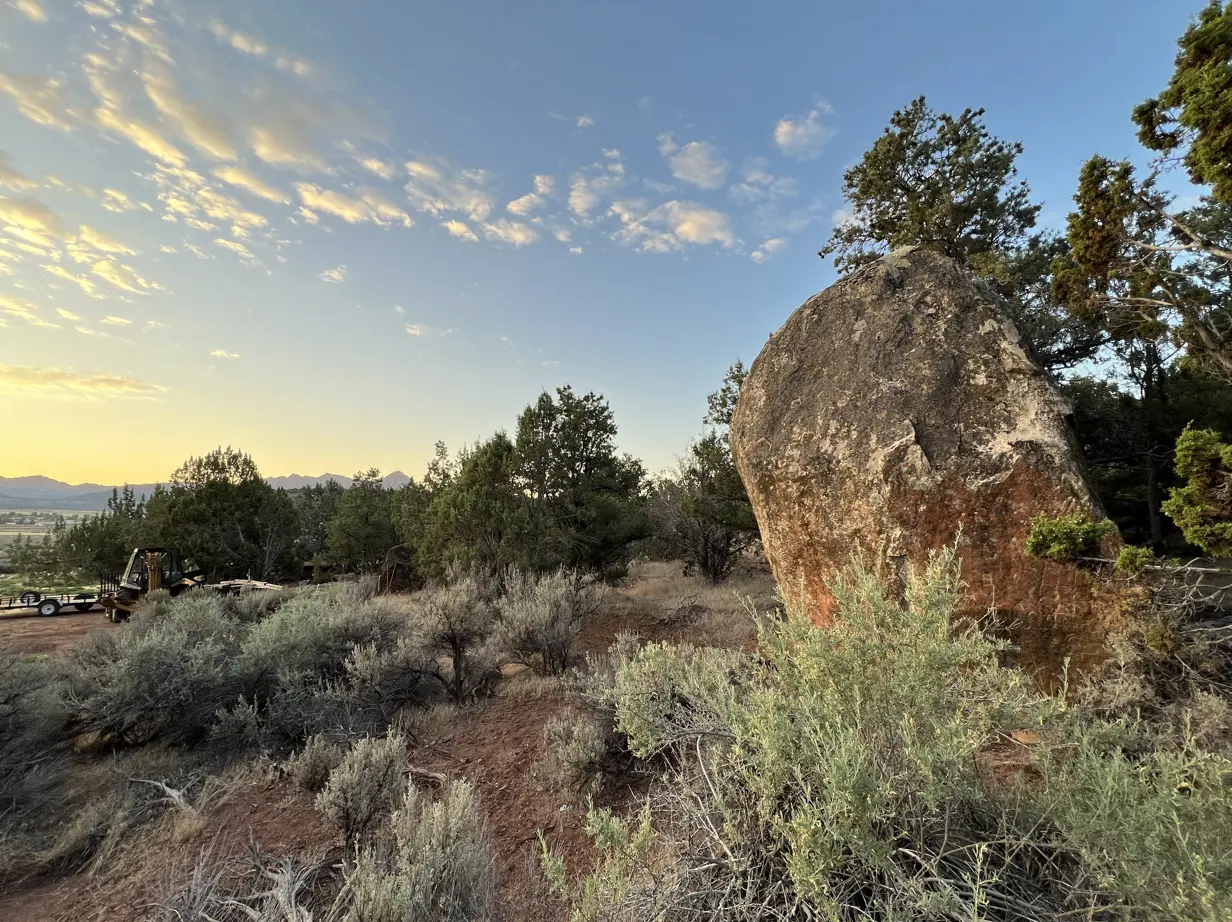 Wide-open desert landscape with red rock outcroppings